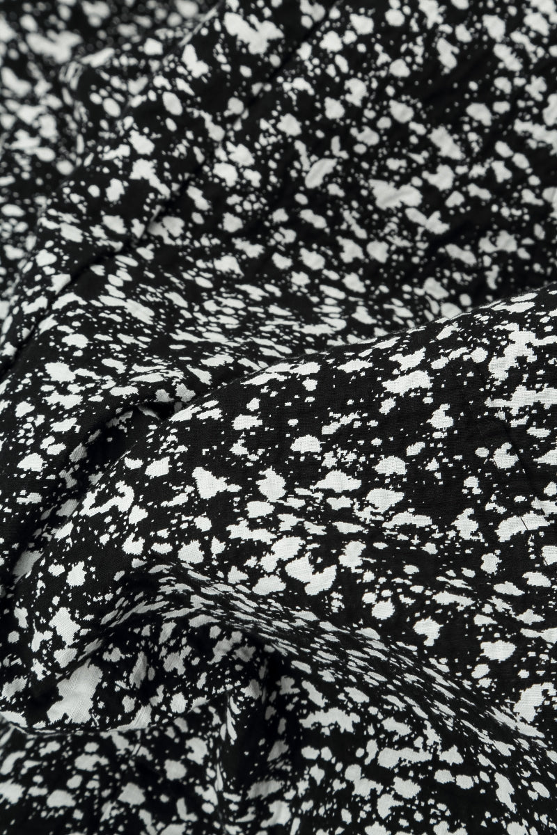 Pantalon boutonné en coton moucheté noir et blanc