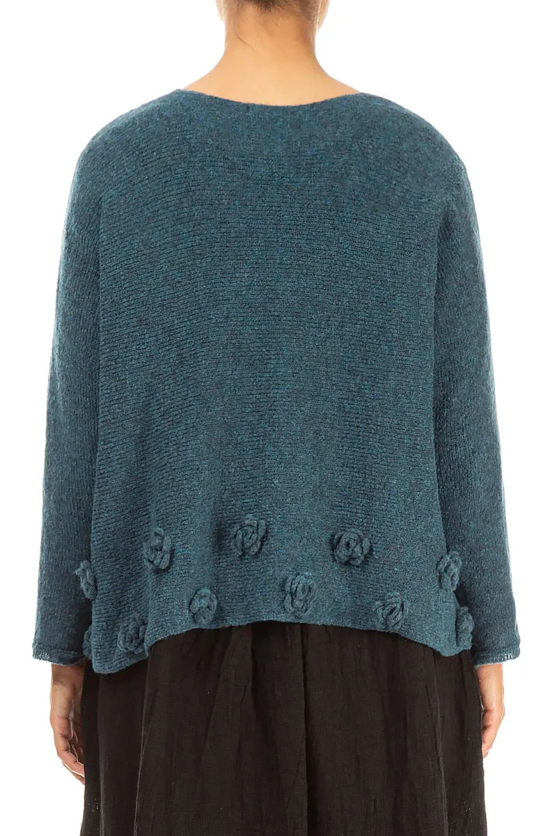 Pull en laine bleu sarcelle à fleurs