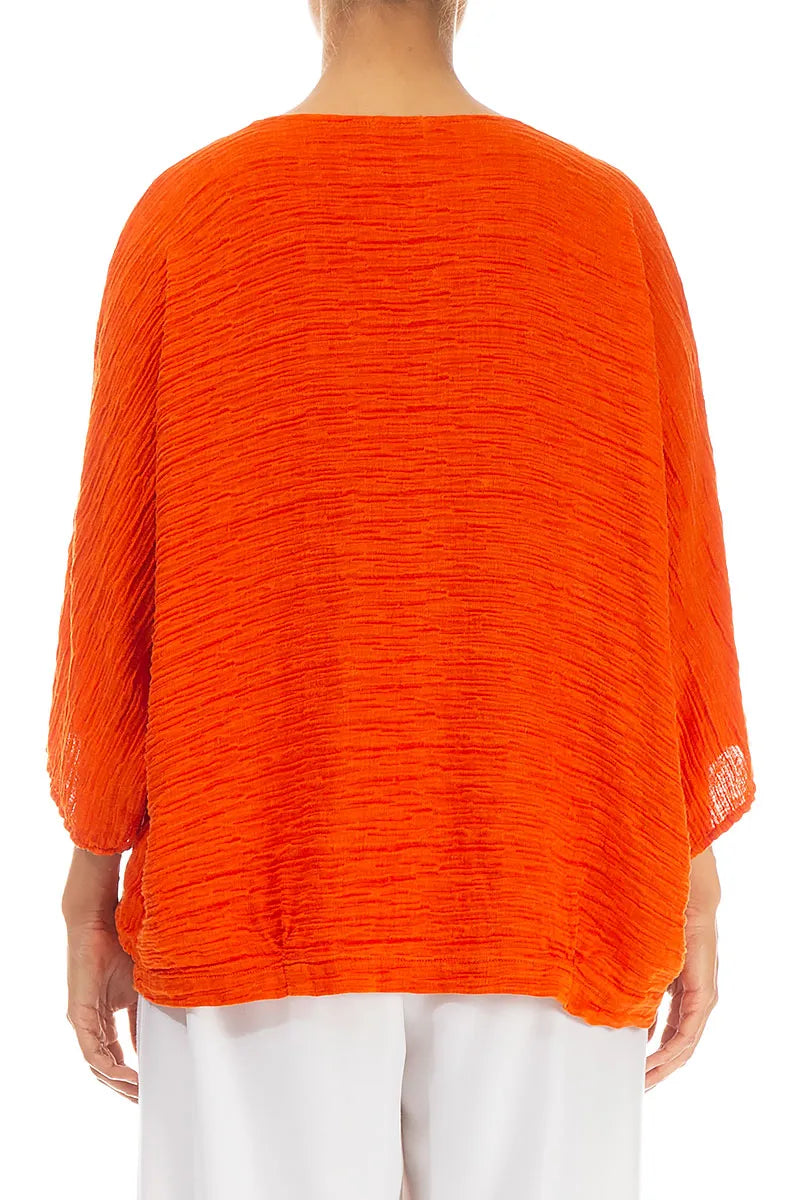 Lockere, gekreppte, flammenorangefarbene Seidenbluse