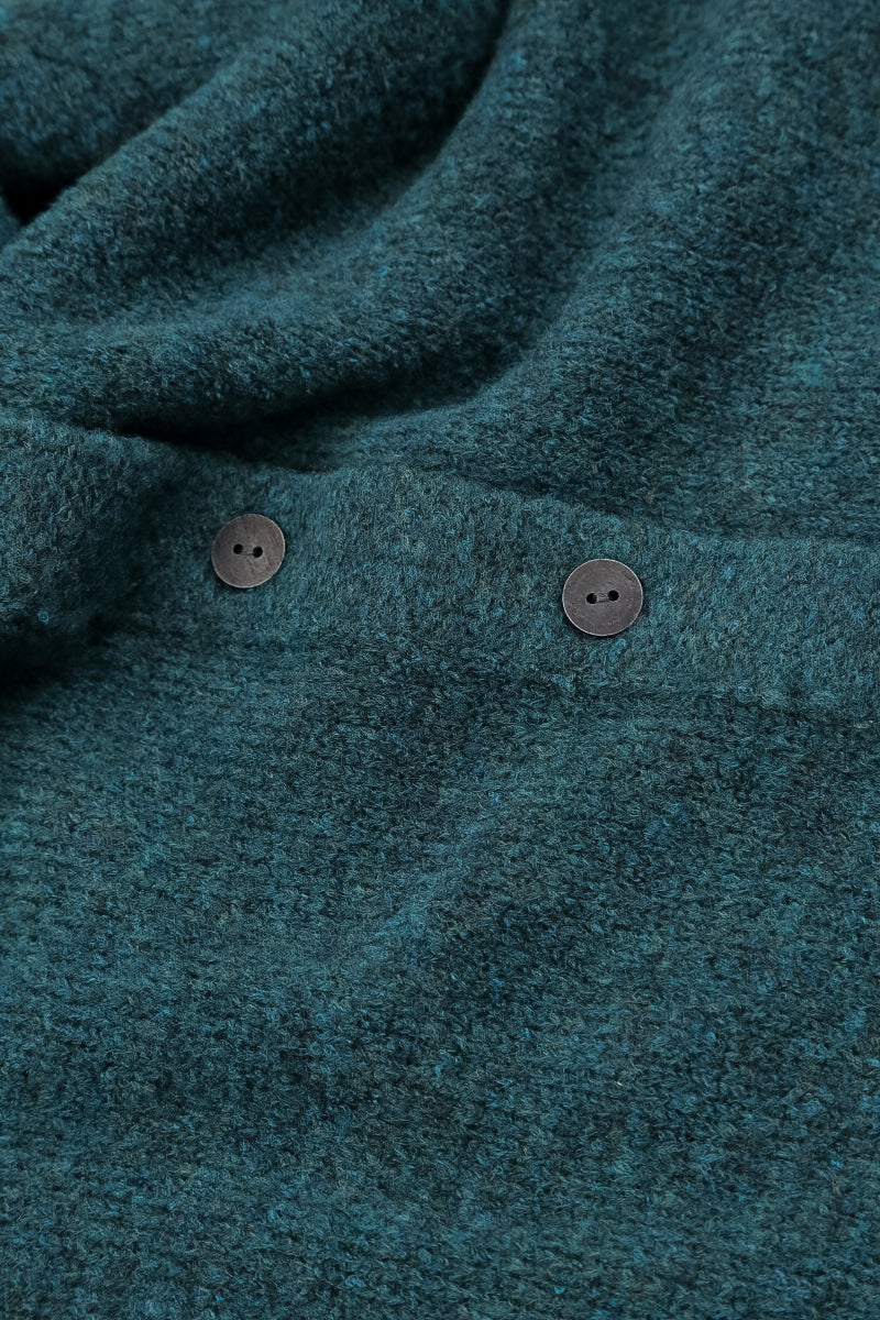 Gilet en laine turquoise à col volanté